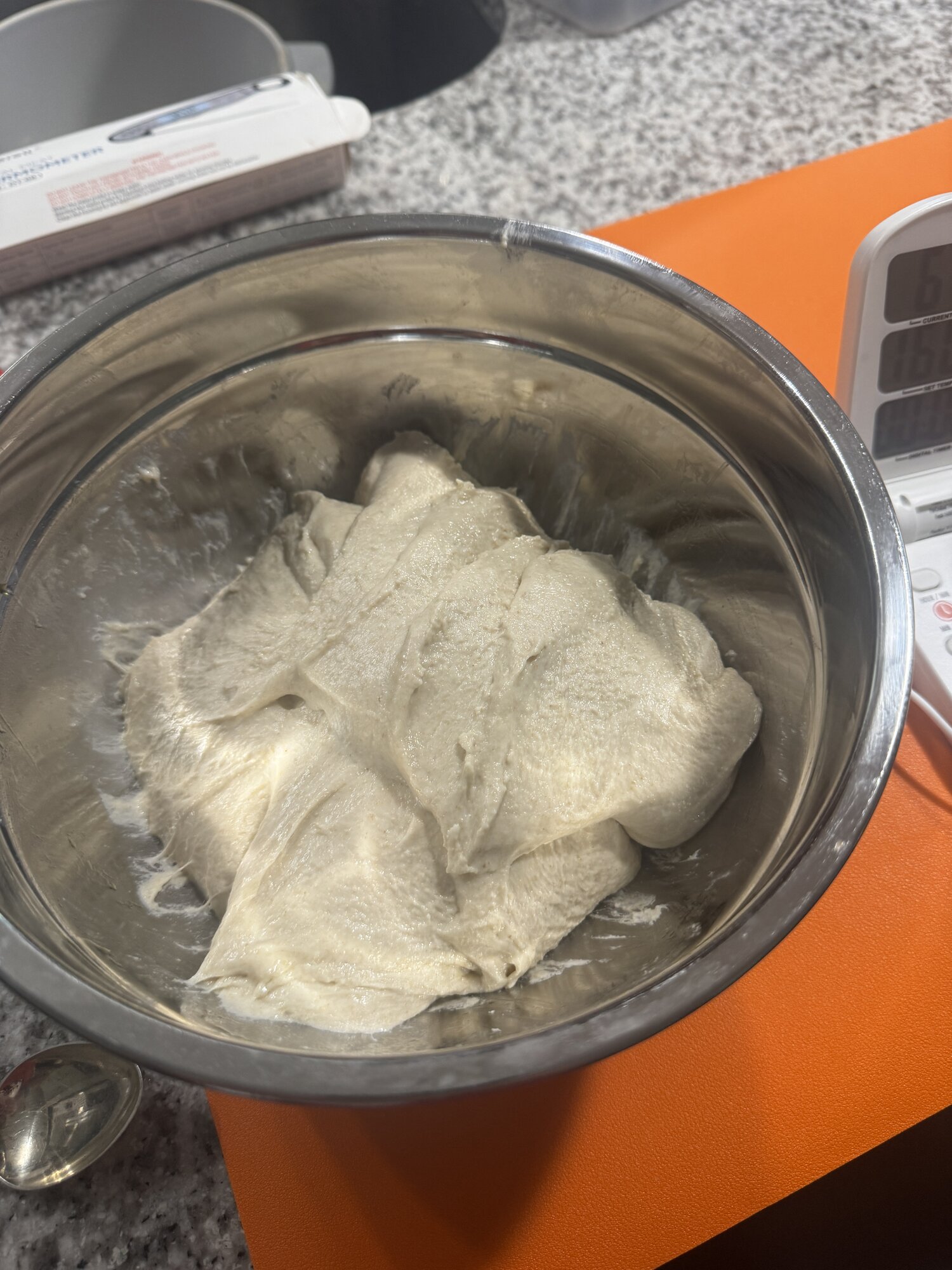 The dough stretching more smoothly after the second fold.